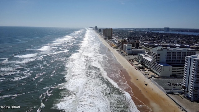 birds eye view of property featuring a view of the beach, a water view, and a city view