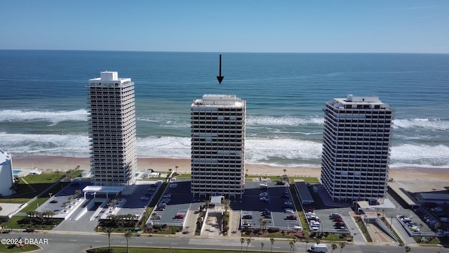 birds eye view of property featuring a beach view and a water view