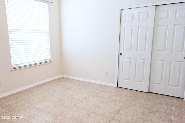 3288 Spruce Creek Gln, Port Orange, FL 32128 - unfurnished bedroom with light tile patterned floors and a closet