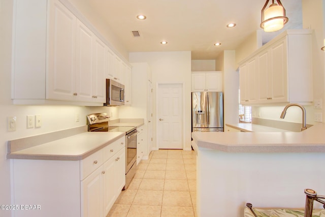 3288 Spruce Creek Gln, Port Orange, FL 32128 - kitchen featuring appliances with stainless steel finishes, a peninsula, recessed lighting, light countertops, and white cabinets