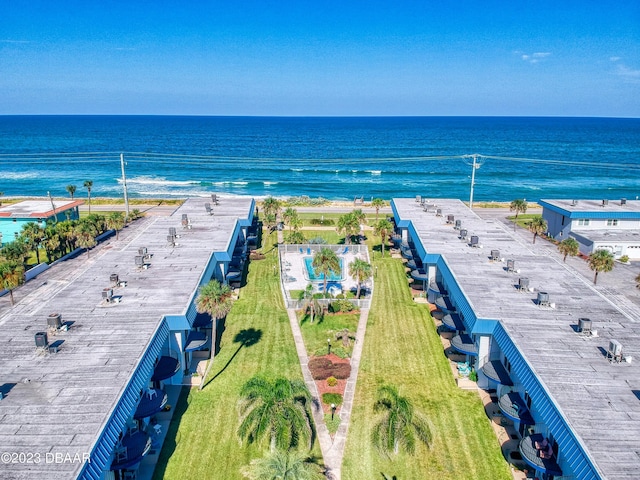 bird's eye view with a water view and a beach view