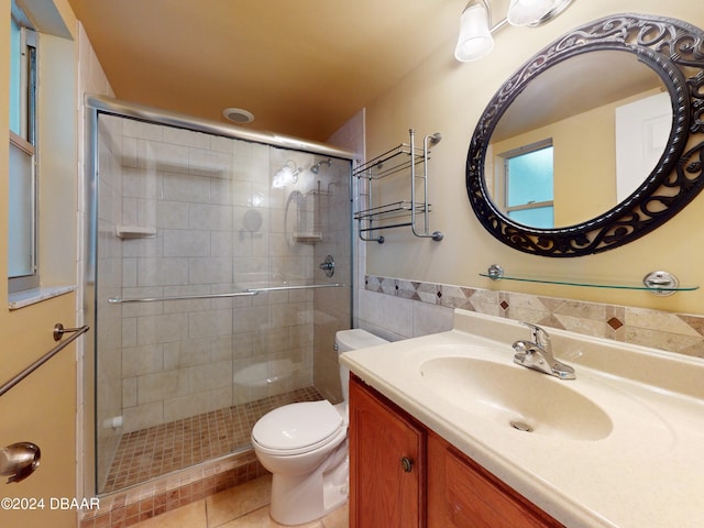 full bath with vanity, a shower stall, toilet, and tile patterned floors