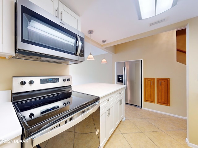 kitchen featuring white cabinets, appliances with stainless steel finishes, hanging light fixtures, and light tile patterned flooring