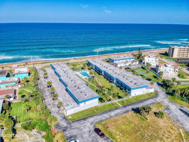 drone / aerial view featuring a view of the beach and a water view