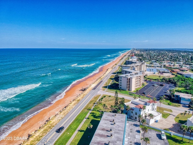 drone / aerial view featuring a water view and a beach view