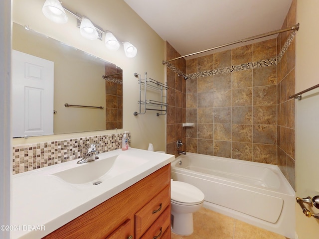 bathroom featuring decorative backsplash, toilet,  shower combination, tile patterned flooring, and vanity