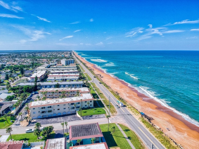 aerial view with a water view and a beach view