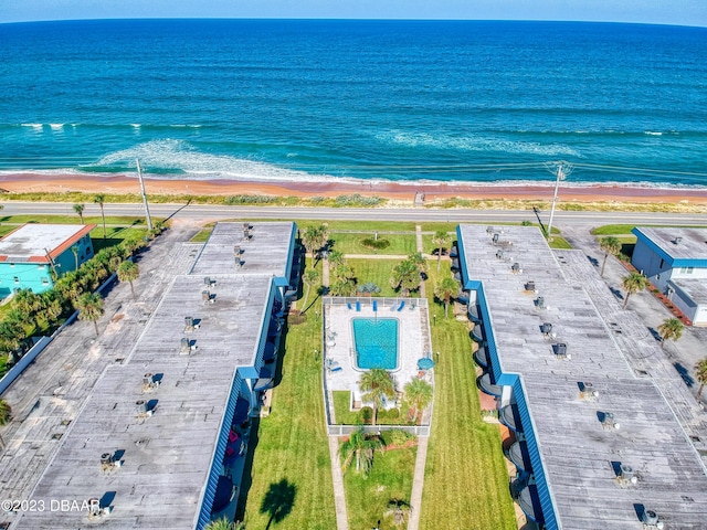 birds eye view of property featuring a beach view and a water view