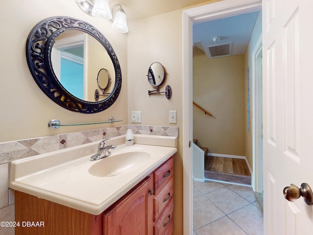 bathroom with visible vents, vanity, and tile patterned floors