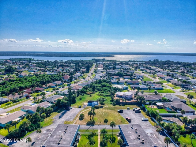 birds eye view of property with a water view and a residential view