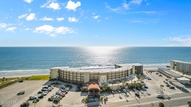 birds eye view of property featuring a water view and a beach view