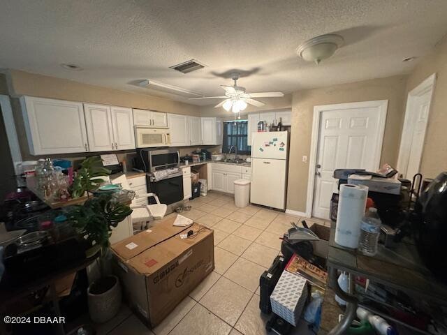 kitchen featuring white cabinets, sink, light tile patterned flooring, ceiling fan, and white appliances