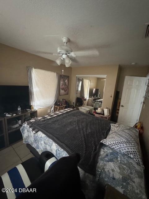 bedroom featuring ceiling fan and a closet