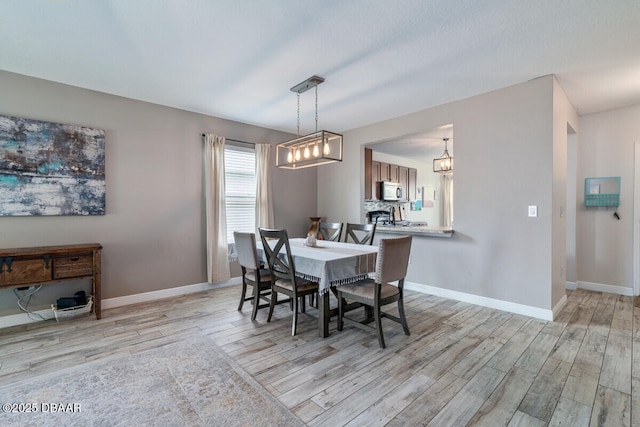 1743 Savannah Ln, Port Orange, FL 32128 - dining space featuring light wood-style floors and a chandelier
