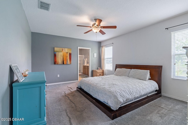 1743 Savannah Ln, Port Orange, FL 32128 - carpeted bedroom with multiple windows, a ceiling fan, and ensuite bath