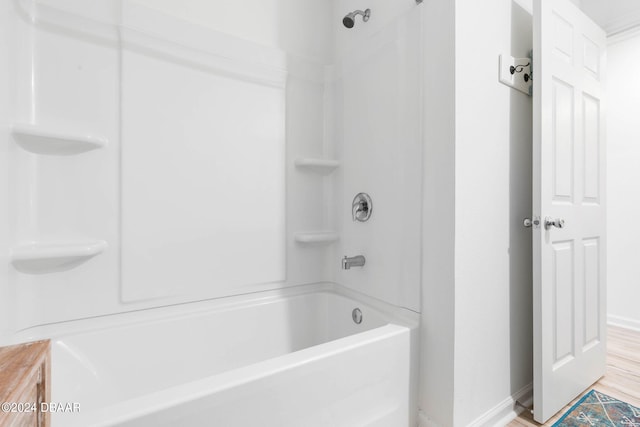 bathroom featuring bathtub / shower combination and wood-type flooring