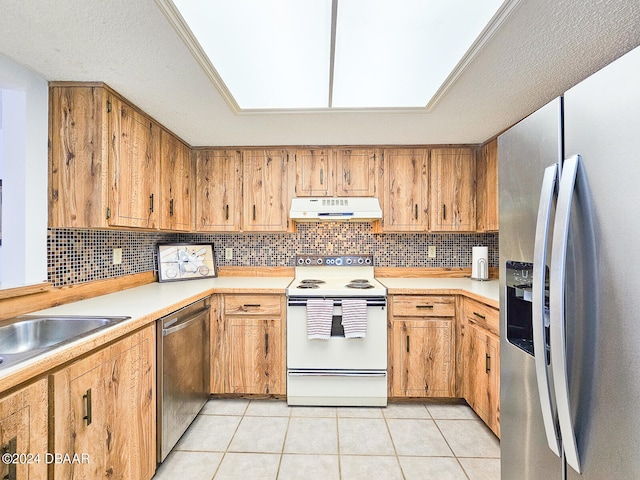 kitchen with backsplash, appliances with stainless steel finishes, a textured ceiling, and light tile patterned floors