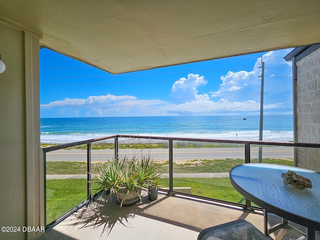 balcony with a view of the beach and a water view