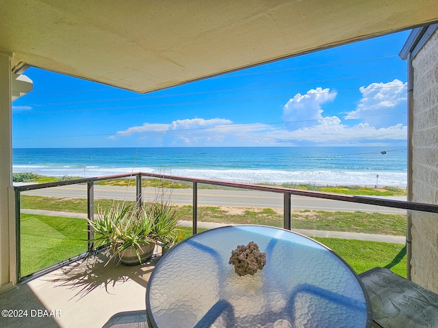 balcony with a view of the beach and a water view