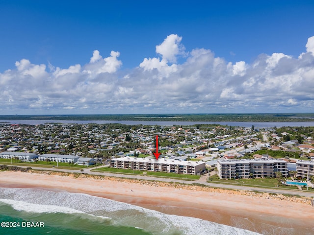 drone / aerial view featuring a beach view and a water view