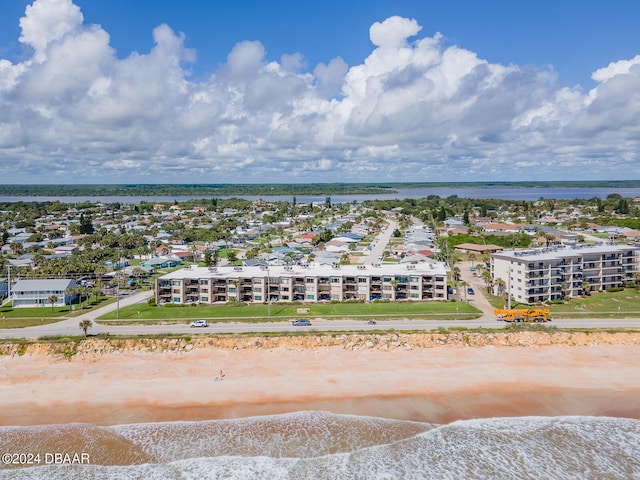 birds eye view of property featuring a view of the beach and a water view