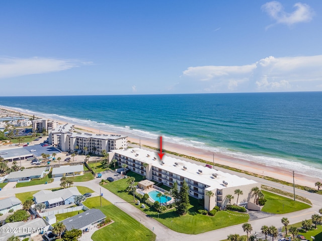 birds eye view of property with a beach view and a water view