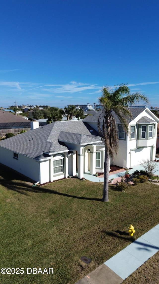 view of front of house featuring a garage and a front yard