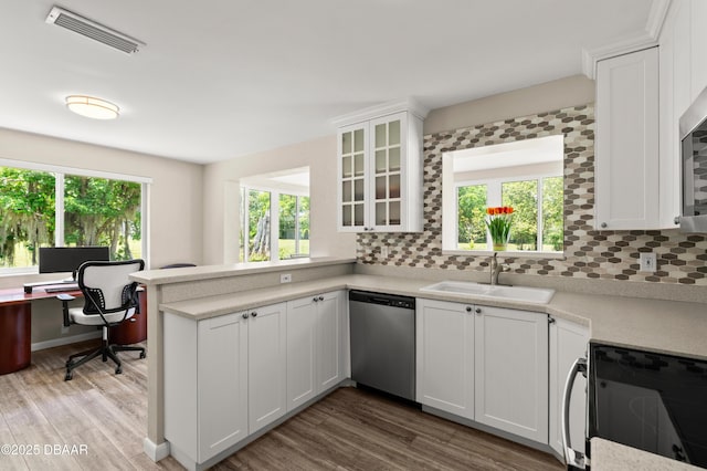 1010/1020 Big Tree Rd, Daytona Beach, FL 32119 - kitchen with stainless steel dishwasher, black range with electric stovetop, healthy amount of natural light, and decorative backsplash