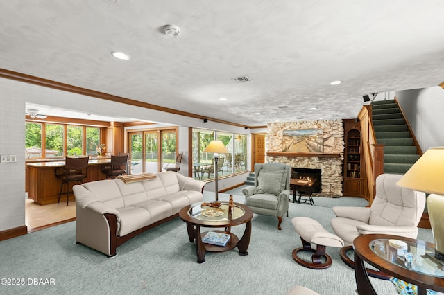 1010/1020 Big Tree Rd, Daytona Beach, FL 32119 - living area featuring light carpet, ornamental molding, a stone fireplace, stairs, and recessed lighting