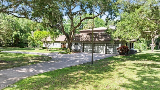 1010/1020 Big Tree Rd, Daytona Beach, FL 32119 - view of front of house featuring concrete driveway, a garage, and a front yard