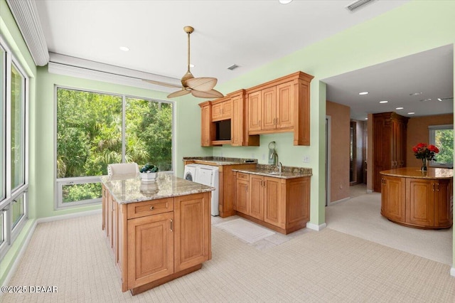 1010/1020 Big Tree Rd, Daytona Beach, FL 32119 - kitchen featuring a kitchen island, light carpet, a ceiling fan, light stone countertops, and recessed lighting