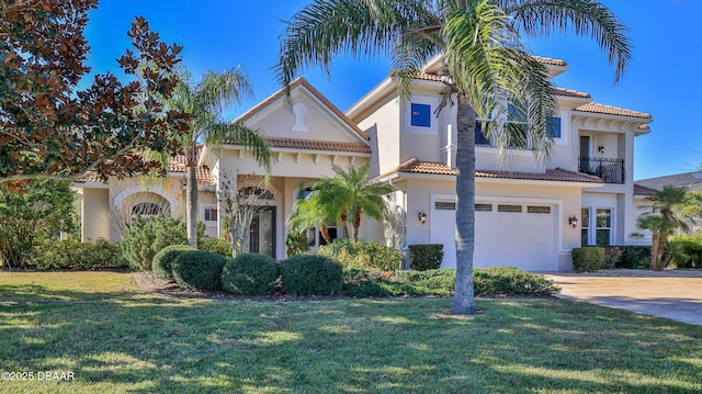 mediterranean / spanish home featuring a garage and a front yard