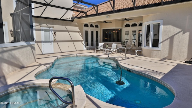 view of swimming pool featuring glass enclosure, ceiling fan, french doors, and a patio area