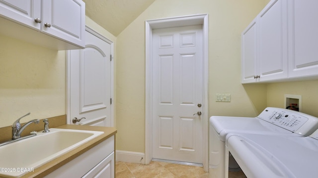 washroom with washing machine and dryer, sink, and cabinets