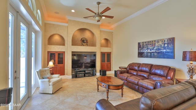 living room with ceiling fan, french doors, built in features, light tile patterned floors, and ornamental molding