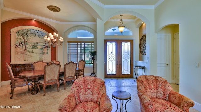 entrance foyer featuring crown molding, french doors, light tile patterned flooring, and a chandelier