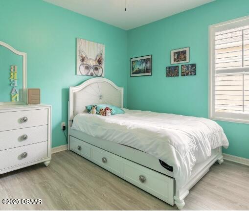 2672 Star Coral Ln, New Smyrna Beach, FL 32168 - bedroom featuring light wood-style floors and multiple windows