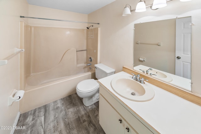 full bathroom with hardwood / wood-style floors, shower / washtub combination, toilet, and vanity