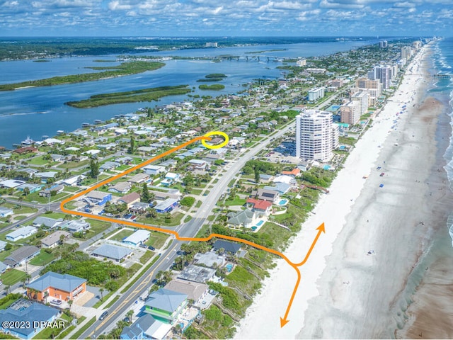 birds eye view of property with a view of the beach and a water view