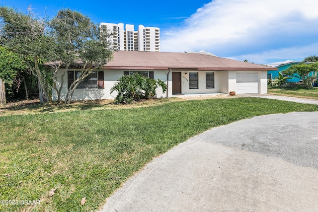 single story home featuring a garage and a front yard