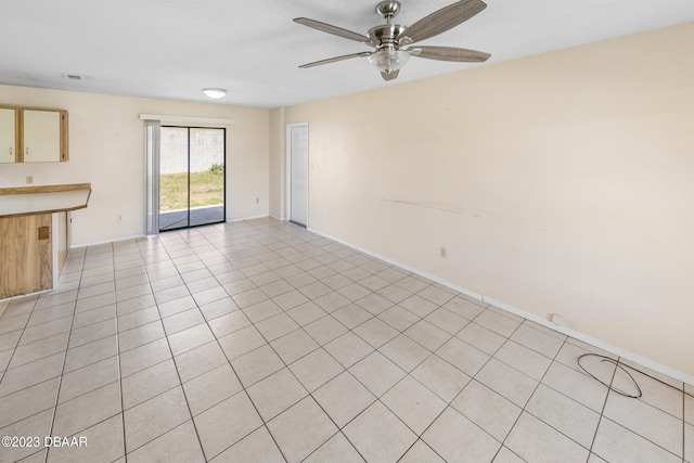 unfurnished living room featuring ceiling fan and light tile patterned floors