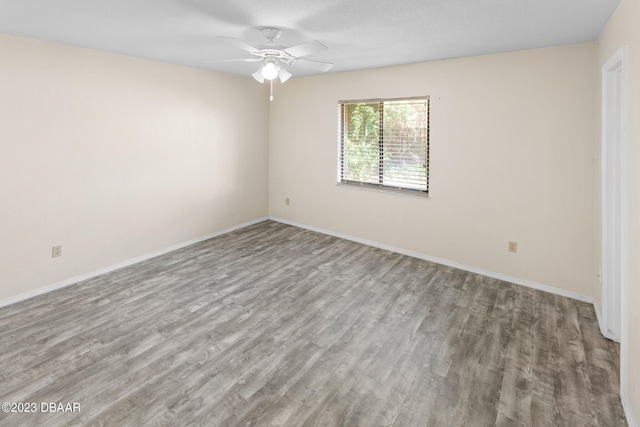 empty room featuring ceiling fan and wood-type flooring