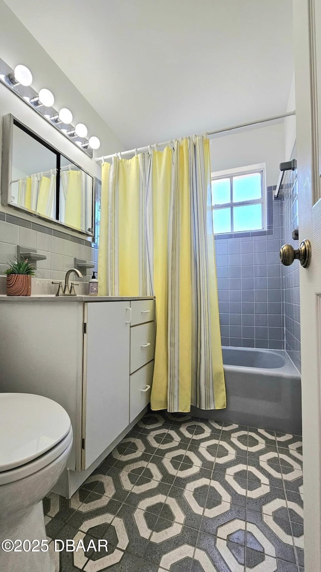 bathroom featuring vanity, shower / tub combo, toilet, and backsplash