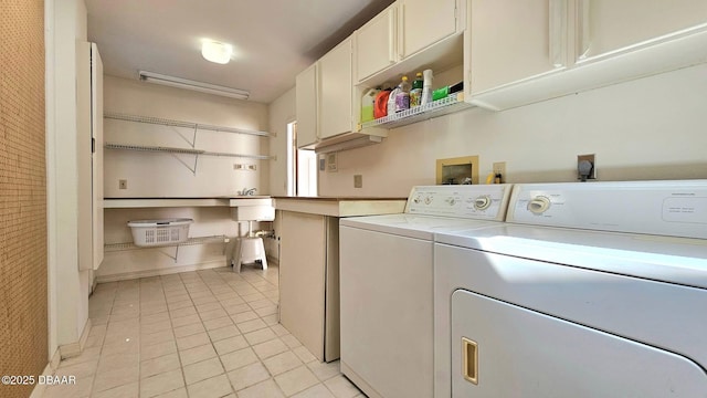 laundry area with cabinet space, light tile patterned floors, washer and dryer, and baseboards