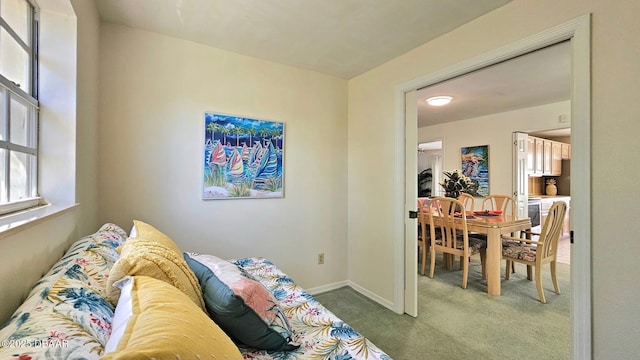 carpeted living area with baseboards