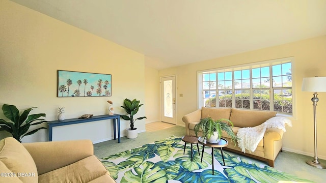 living area featuring carpet flooring and baseboards