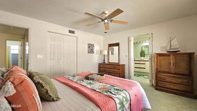 bedroom with visible vents, light carpet, ensuite bath, a closet, and ceiling fan