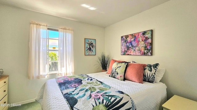 carpeted bedroom featuring baseboards