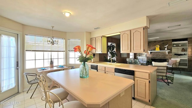 kitchen featuring visible vents, light brown cabinets, light countertops, and a sink