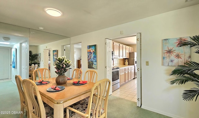 dining area featuring visible vents, light carpet, and light tile patterned flooring